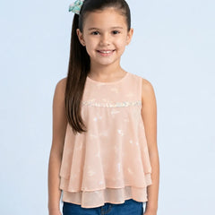 Young girl wearing a light pink top with a subtle pattern on a light blue background