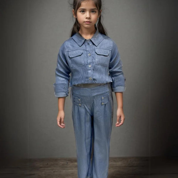 This Light blue Colored dress Consists of a shirt with 2 pockets and pants for a little girl. 
