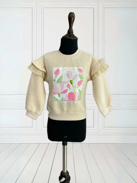 It is a beige Colored sweatshirt that has a printed detailing on it and is enhanced with sequin work.