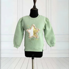 It is a green Colored sweatshirt for girls that has a star print on it and is enhanced with some leafy detailing. 