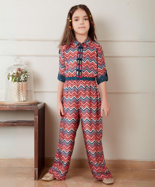 It is a multi colored kids party wear that consists of a printed jumpsuit with an elasticated waist. It features work detailing on the placket.