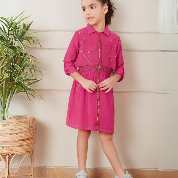  It’s a pink coloured fancy girl dress for a party with an elasticated waist. It features beautiful golden work and chain detailing on the dress.