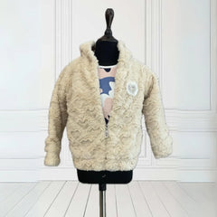  It is a smart Cream Colored winter Jacket for baby girls that comes with a small patch detailing on it.