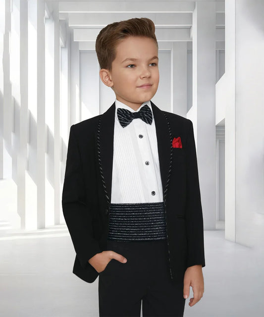 This coat suit for boys consists of a black coat, matching pants, a self-striped waist belt, and a white Colored shirt with pin tucks detailing on it. It features a matching self-striped bow and a red-coloured pocket square.