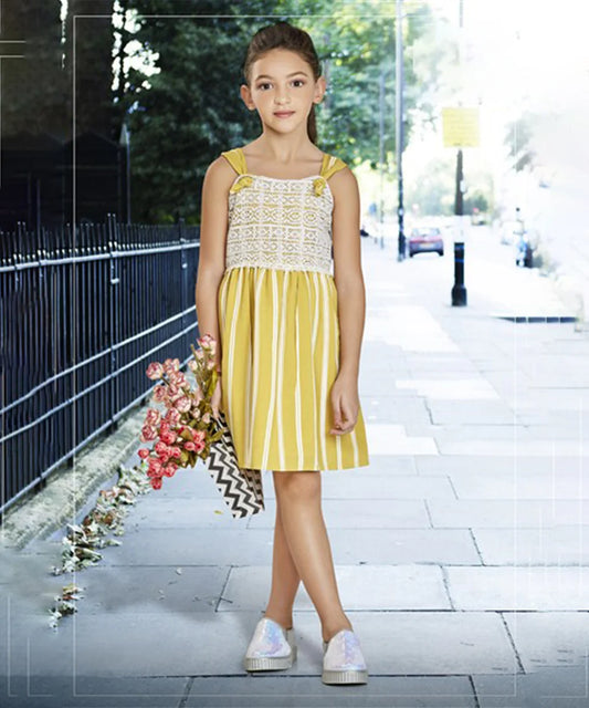  It is a vertical striped Yellow party dress for kid girl. Devils n Angels is a perfect place for online shopping for kids wear in India. It features off-white coloured lace detailing and smocking done at the back part of the dress.