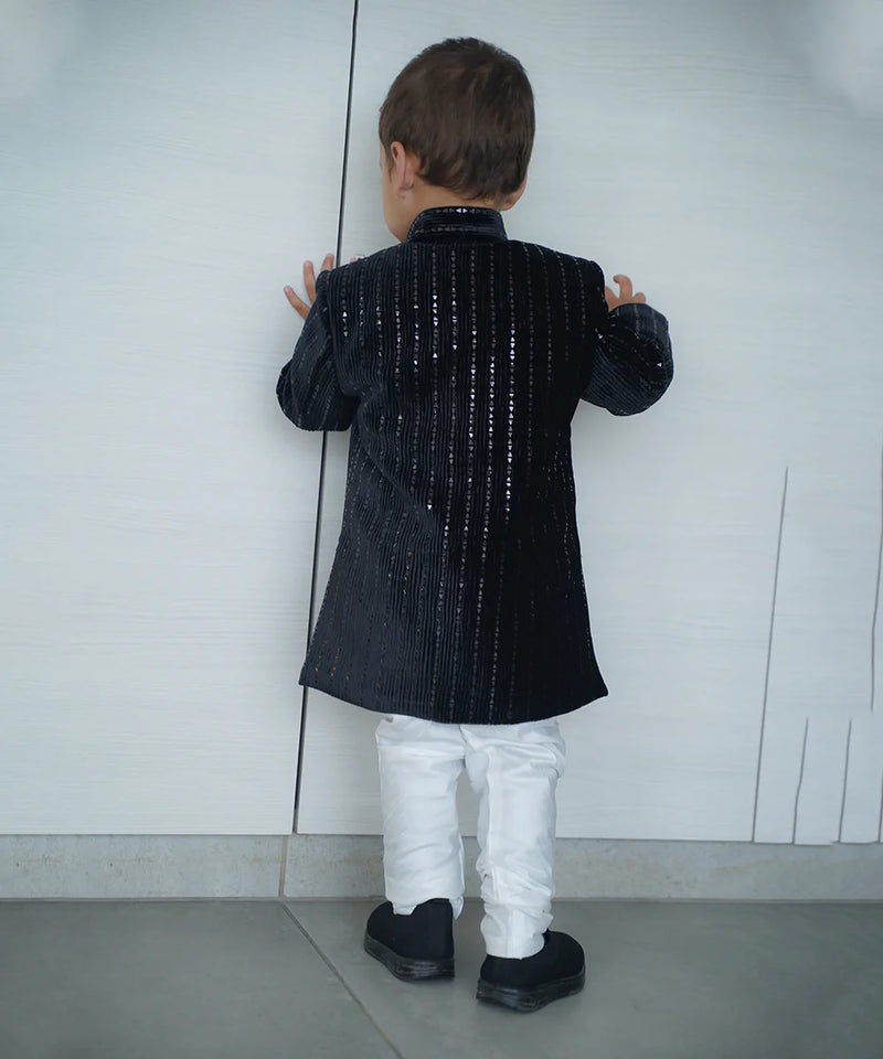 back view of black color velvet achkan 