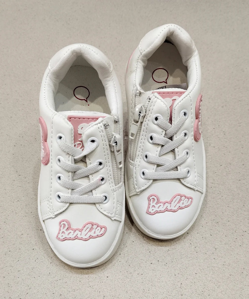White sneakers with pink accents and 'Barbie' branding on a beige background