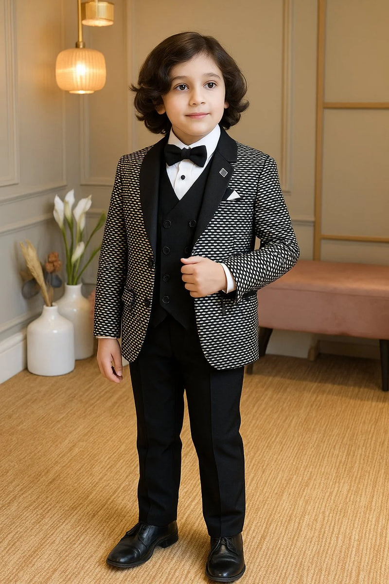 Young boy in a formal suit standing in a room with decorative elements.