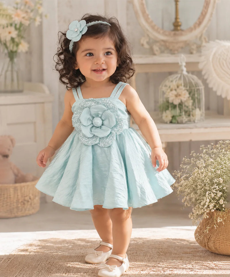 Pastel blue sleeveless baby girl frock with full flared skirt and floral detailing