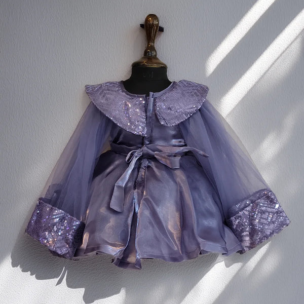Lavender dress with sequin details on a mannequin against a white wall.