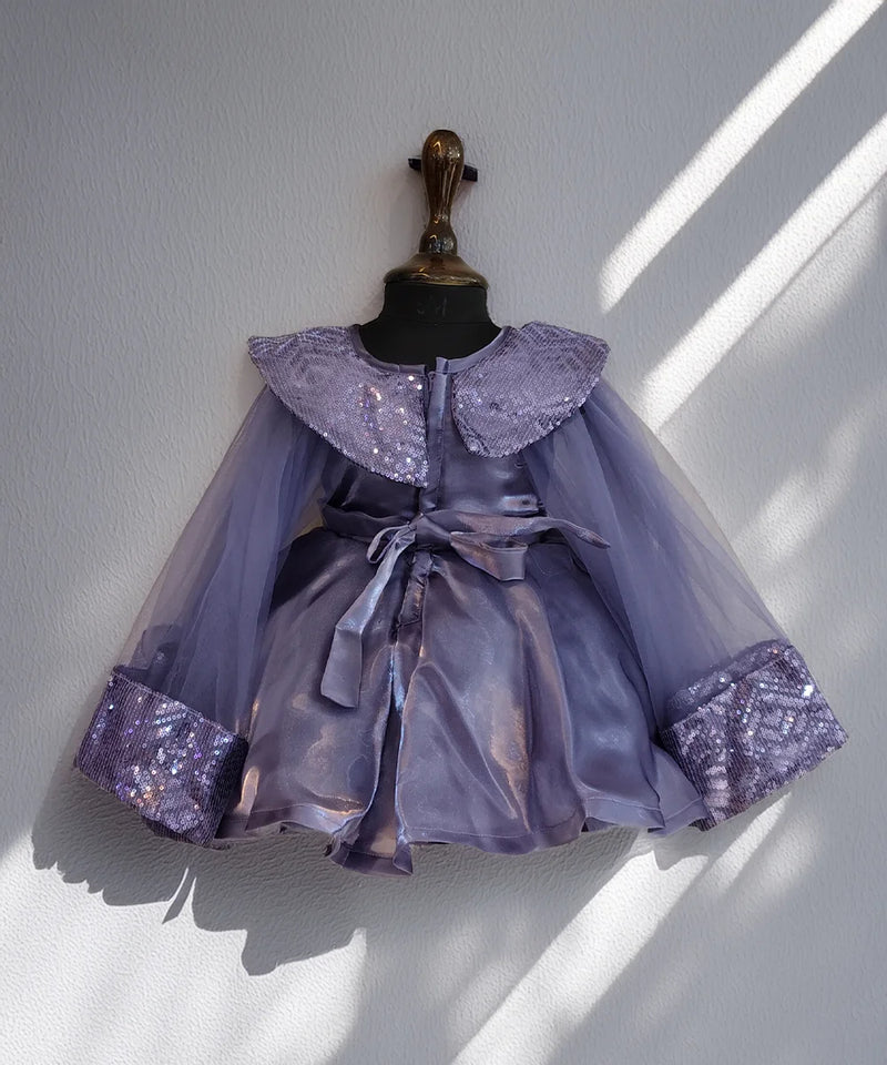 Lavender dress with sequin details on a mannequin against a white wall.