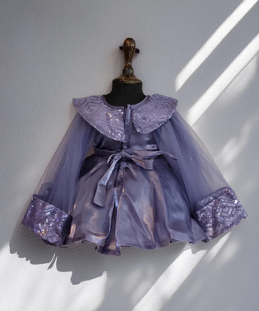 Lavender dress with sequin details on a mannequin against a white wall.