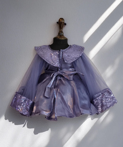 Lavender dress with sequin details on a mannequin against a white wall.