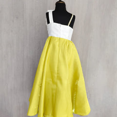 Dress with white top and yellow skirt on a mannequin against a gray background