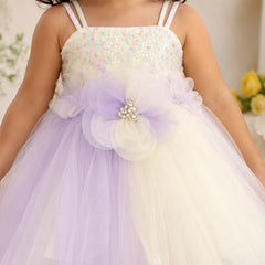 Close-up of layered flower appliqué with pearl-like embellishments on baby girl frock