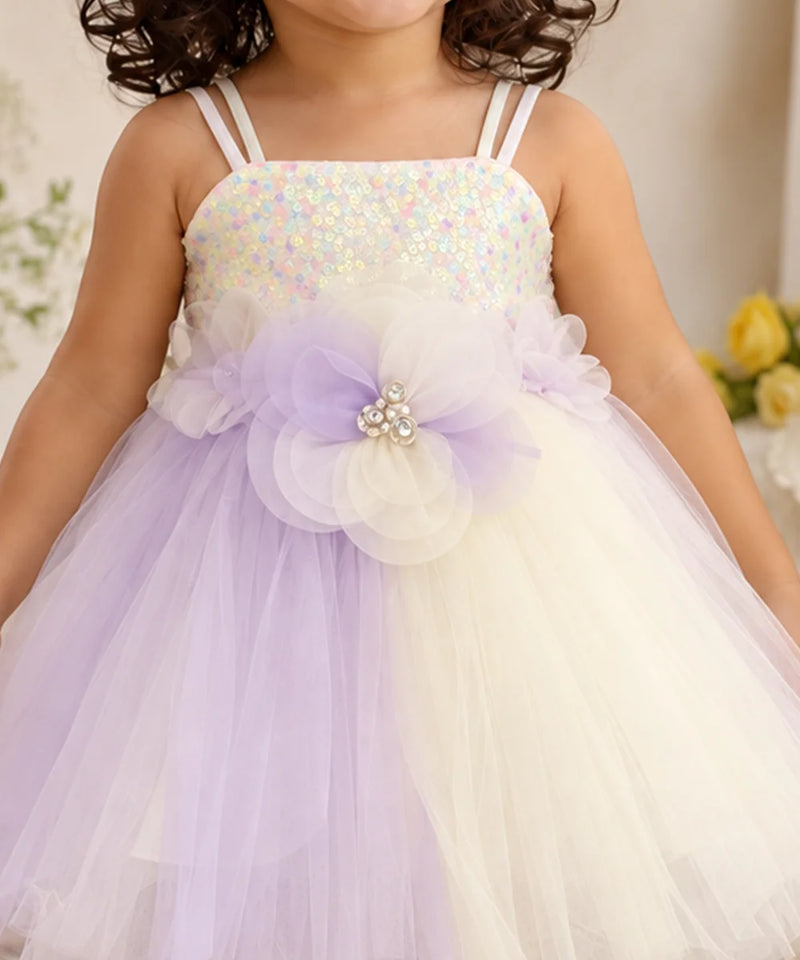 Close-up of layered flower appliqué with pearl-like embellishments on baby girl frock