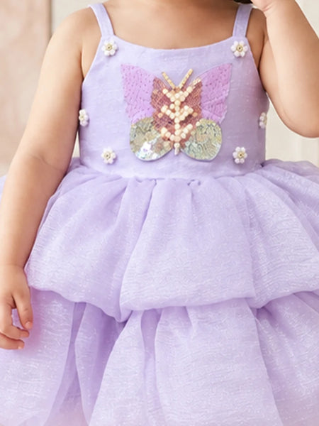 Close-up of baby girls' lilac sequin butterfly frock