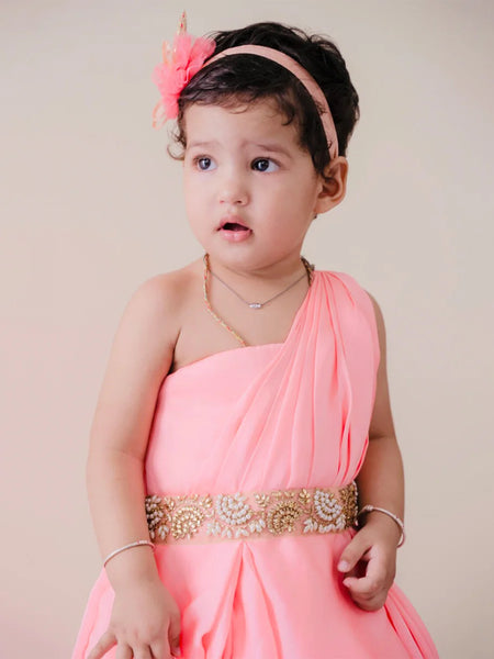  It is a pink Colored gown that comes with back zip closure. It features pearl work and pleated detailing on the dress that uplifts the entire look.