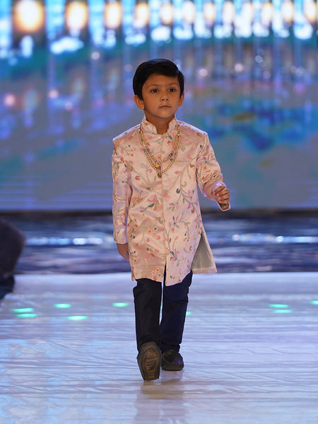  This baby sherwani suit consists of a self-printed Sherwani and a white Colored Pyjama. It features stylized buttons on the sherwani that uplift the entire look.