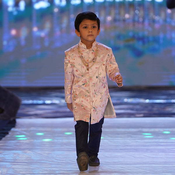  This baby sherwani suit consists of a self-printed Sherwani and a white Colored Pyjama. It features stylized buttons on the sherwani that uplift the entire look.