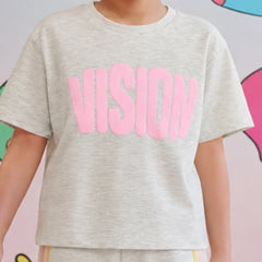 A child wearing a light heather gray short-sleeve t-shirt with the word 'VISION' printed across the chest in large pink letters, paired with matching heather gray pants with thin colored stripes.