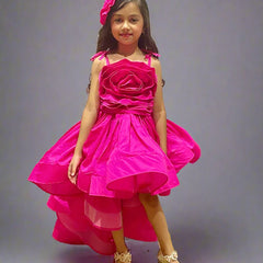 It is a designer neon pink colored up-and-down birthday girl dress that comes with a back hook closure and has a big floral detailing in the dress.