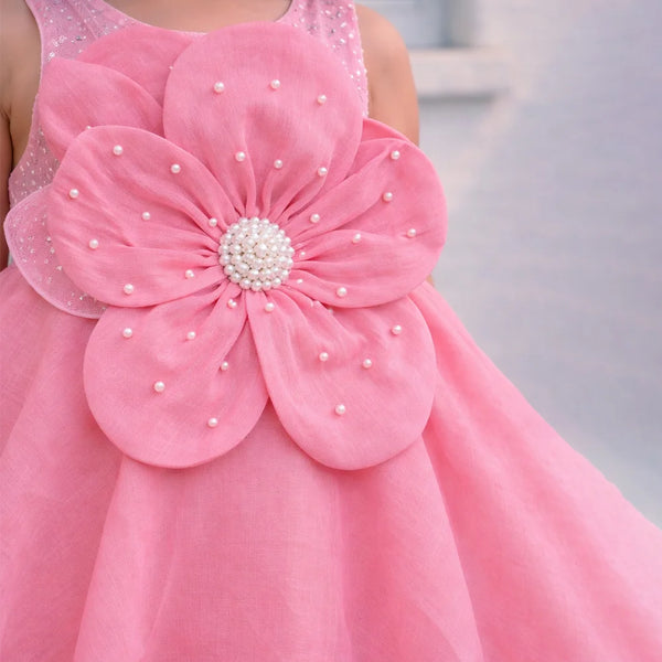 Pink dress with a large flower design on a blurred background