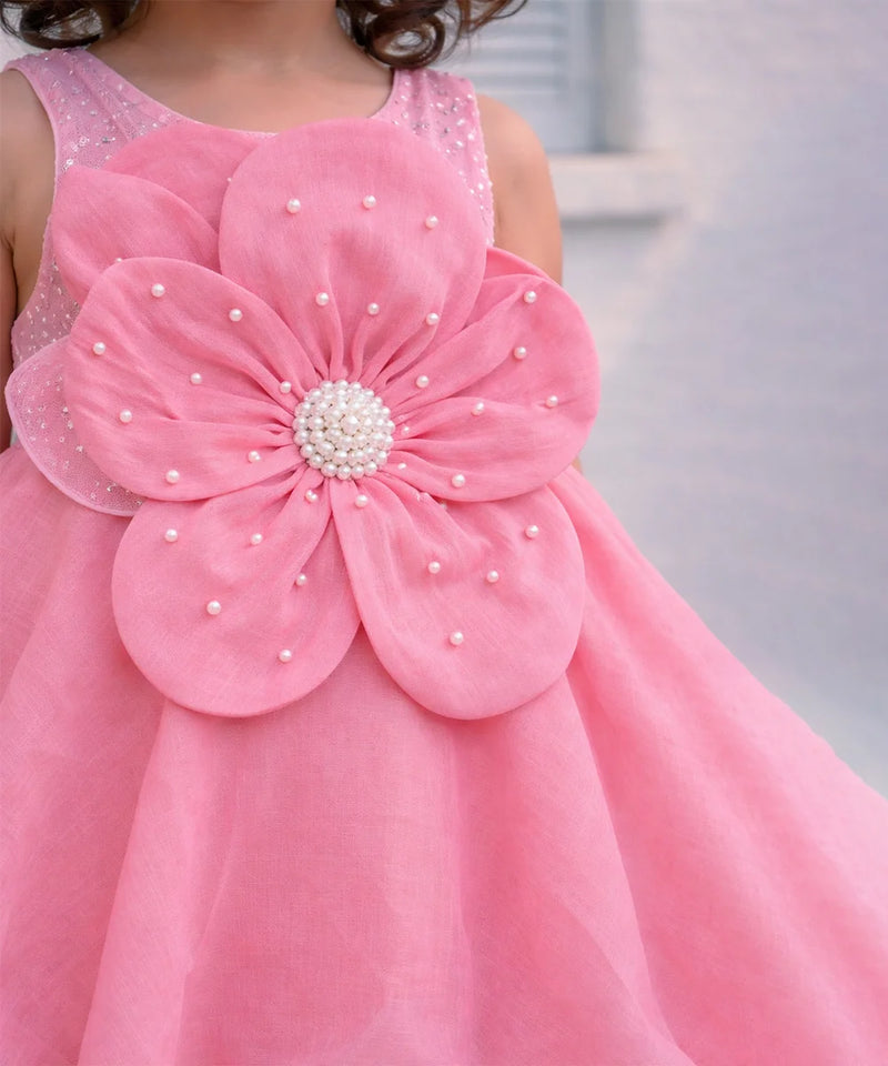 Pink dress with a large flower design on a blurred background
