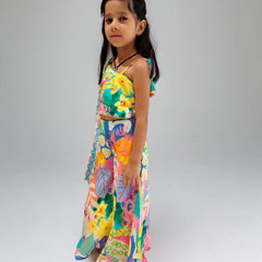 Young girl wearing a colorful floral dress on a plain background