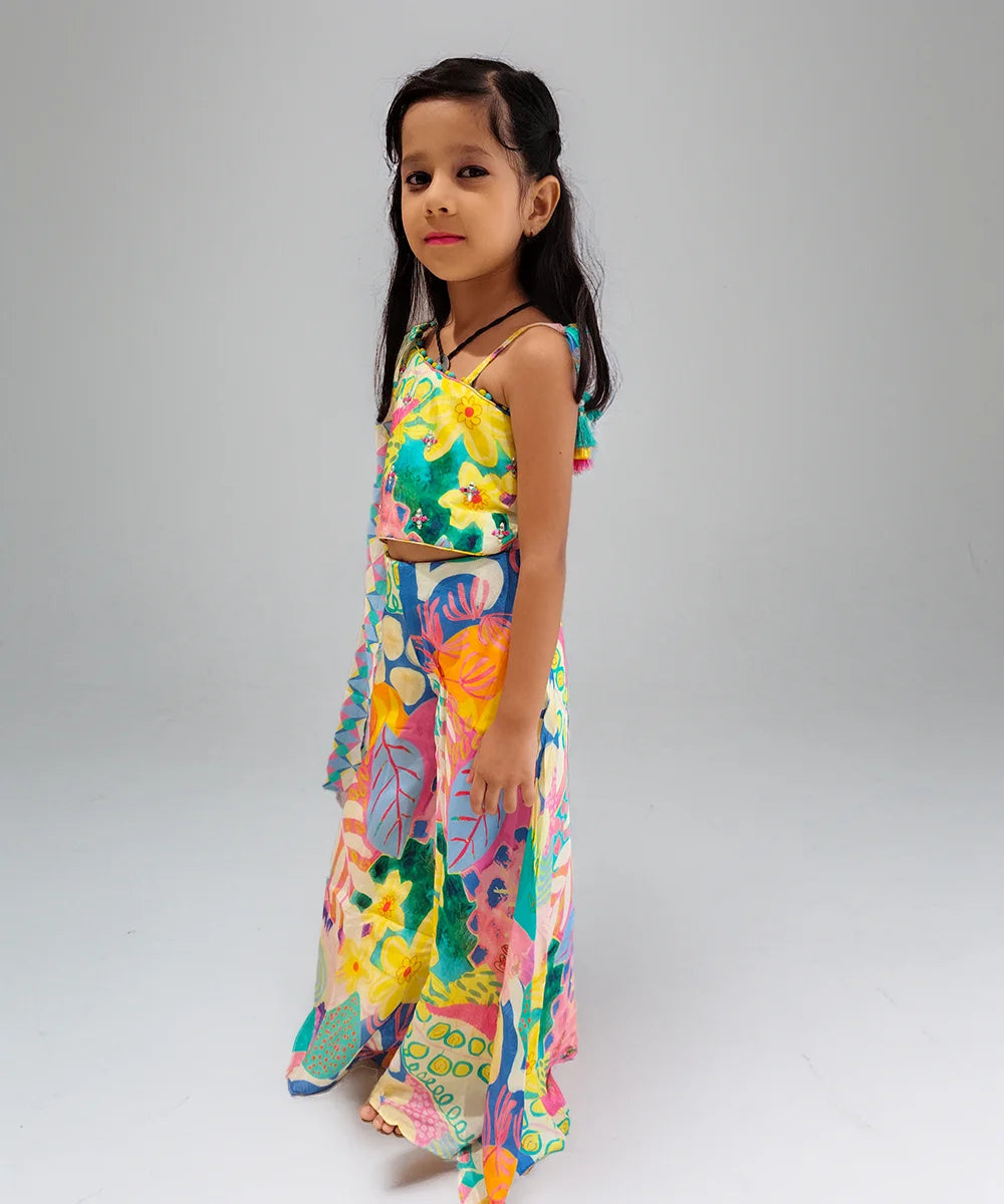 Young girl wearing a colorful floral dress on a plain background