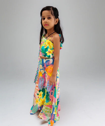 Young girl wearing a colorful floral dress on a plain background