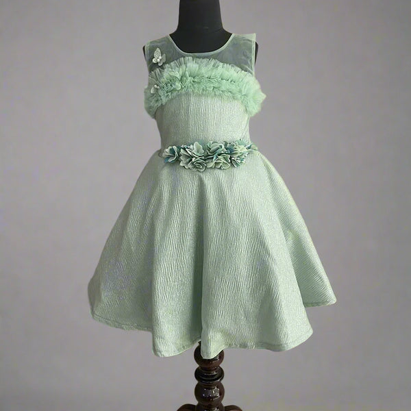  It’s a Pista green Colored shimmery western outfit for kids with a back zip closure and some frilly detailing. It features a cute butterfly and floral detailing.