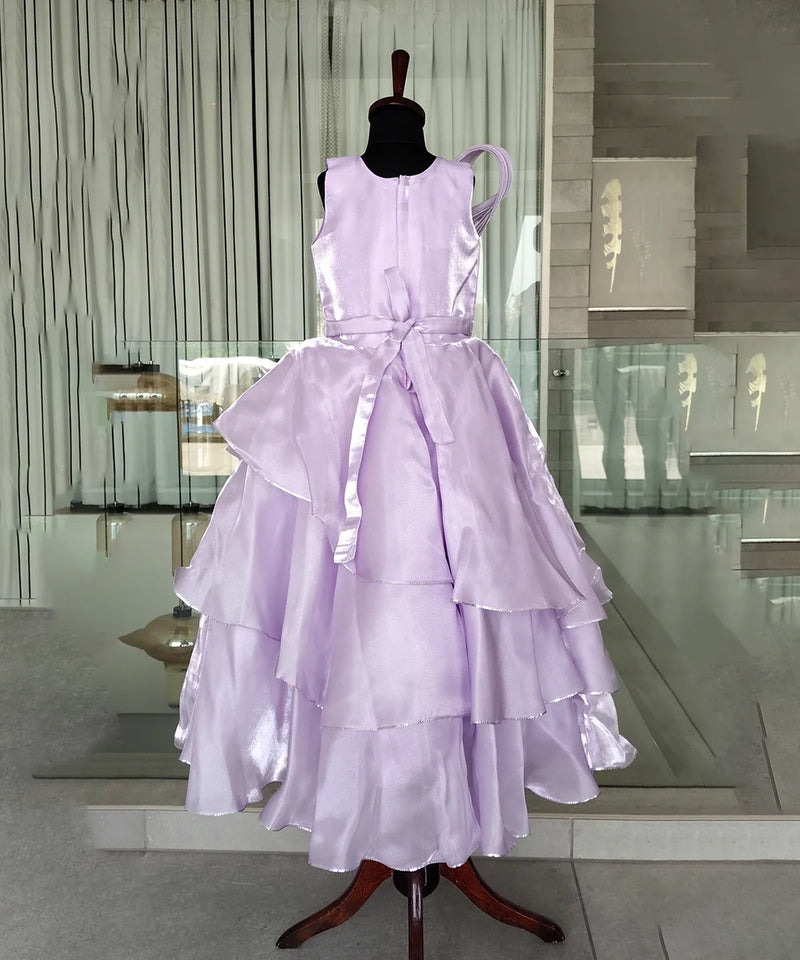 Lavender dress on a mannequin in an indoor setting with reflective floor and wall.