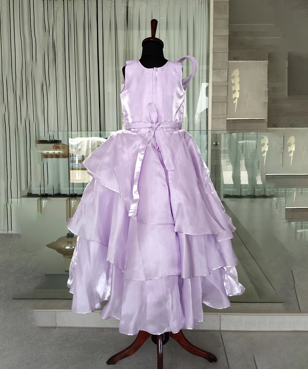 Lavender dress on a mannequin in an indoor setting with reflective floor and wall.