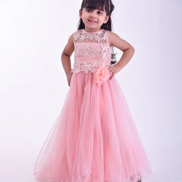 Young girl wearing a pink dress with floral details on a white background