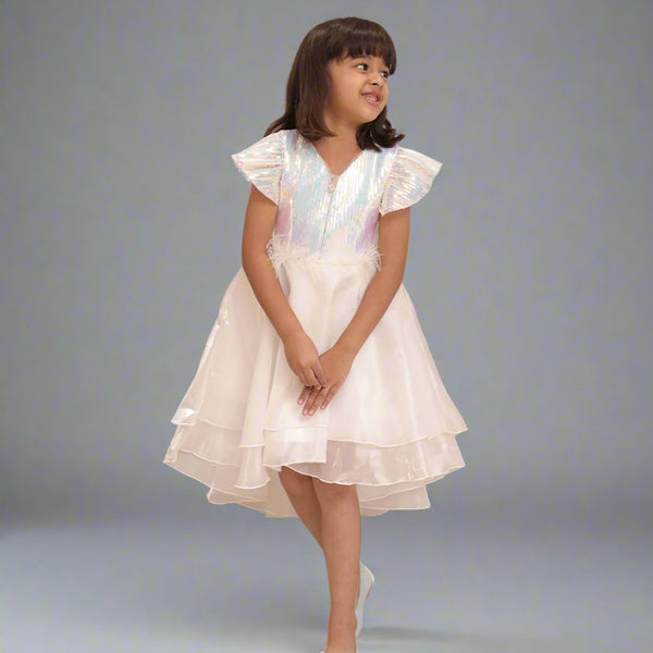 It's a cute white coloured up-and-down birthday frock with a back zip closure. A perfect marriage wears for girls. It features a bow on the back and beautiful feather detailing on the waist that uplifts the entire look.