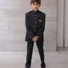  It is a black Jodhpuri suit set which consists of a Jodhpuri Coat along with matching pants. It features stylized buttons, a red coloured pocket square and a nice broach.