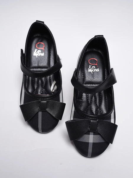Close-up of classic check flats with black bow accent and flexible sole for girls, Jaipur