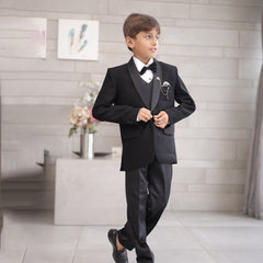 This boys wedding outfit consists of a black Colored shimmer coat, waistcoat, matching pants and a white Colored shirt that comes with pin tucks detailing on it. It features a matching shimmer bow, a broach and a printed pocket square that uplifts the entire look.