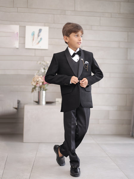 This boys wedding outfit consists of a black Colored shimmer coat, waistcoat, matching pants and a white Colored shirt that comes with pin tucks detailing on it. It features a matching shimmer bow, a broach and a printed pocket square that uplifts the entire look.