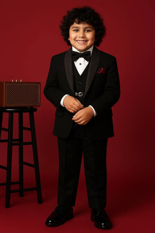 Child in a formal black suit standing against a red background