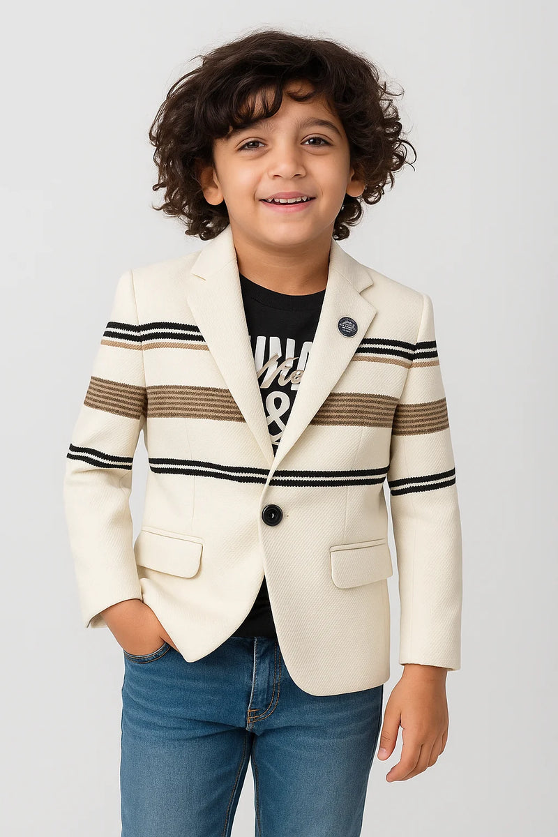 Child wearing a cream blazer with black and brown striped sleeves on a light gray background
