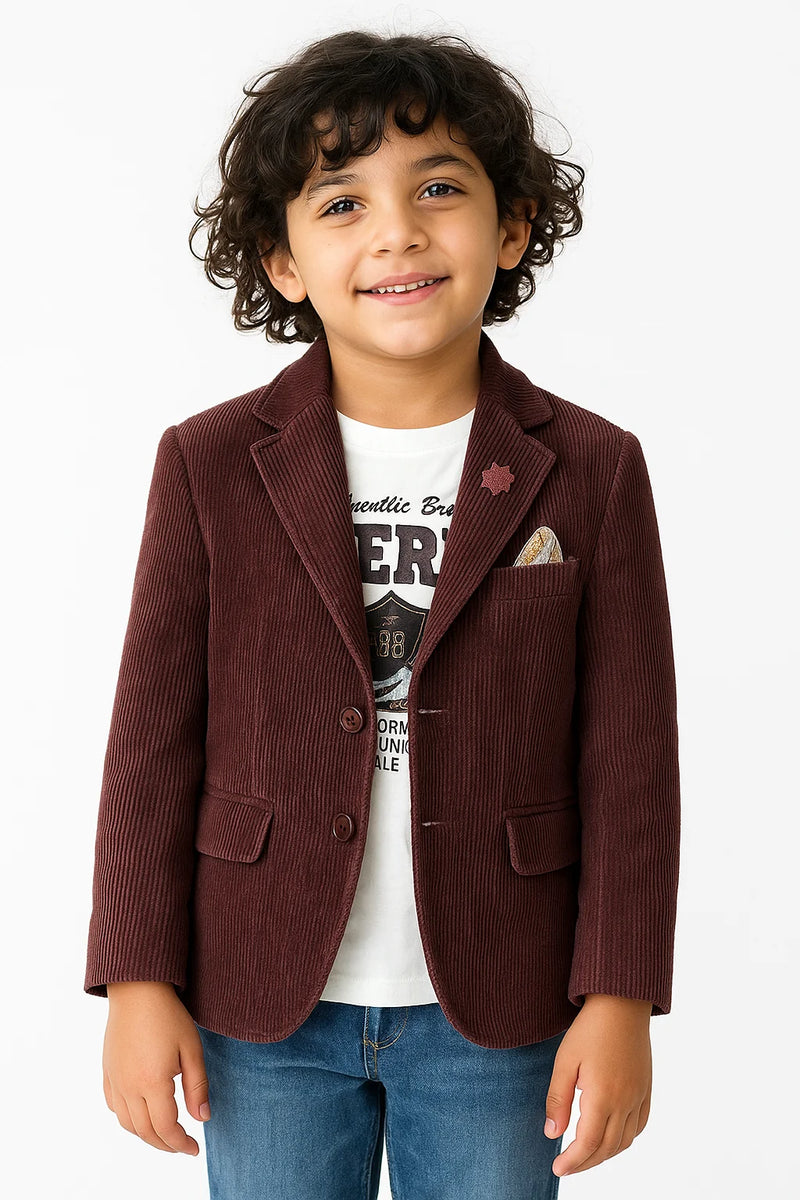 Child wearing a brown corduroy blazer over a graphic t-shirt on a white background