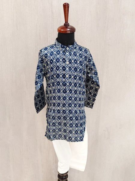 Blue patterned kurta on a mannequin against a beige background
