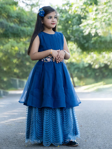 It’s the blue Colored gowns for kids that comes with the back zip closure. Moreover, it is paired up with short sleeves that can be stitched as per requirement. It features embroidery work on the waist, the fabric belt to be tied at the back and a self-embroidered fabric.