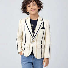 Child wearing a white blazer with black trim on a light gray background