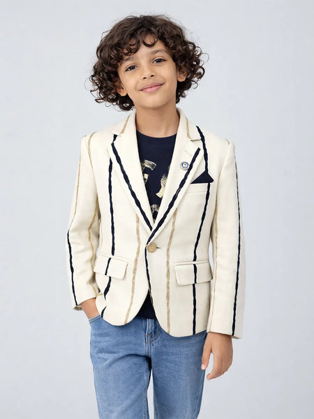Child wearing a white blazer with black trim on a light gray background