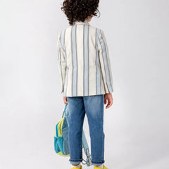 Child wearing a striped shirt and jeans with a colorful backpack on a white background