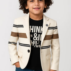 Child wearing a cream blazer with striped sleeves and a black t-shirt on a white background