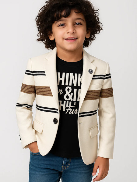 Child wearing a cream blazer with striped sleeves and a black t-shirt on a white background